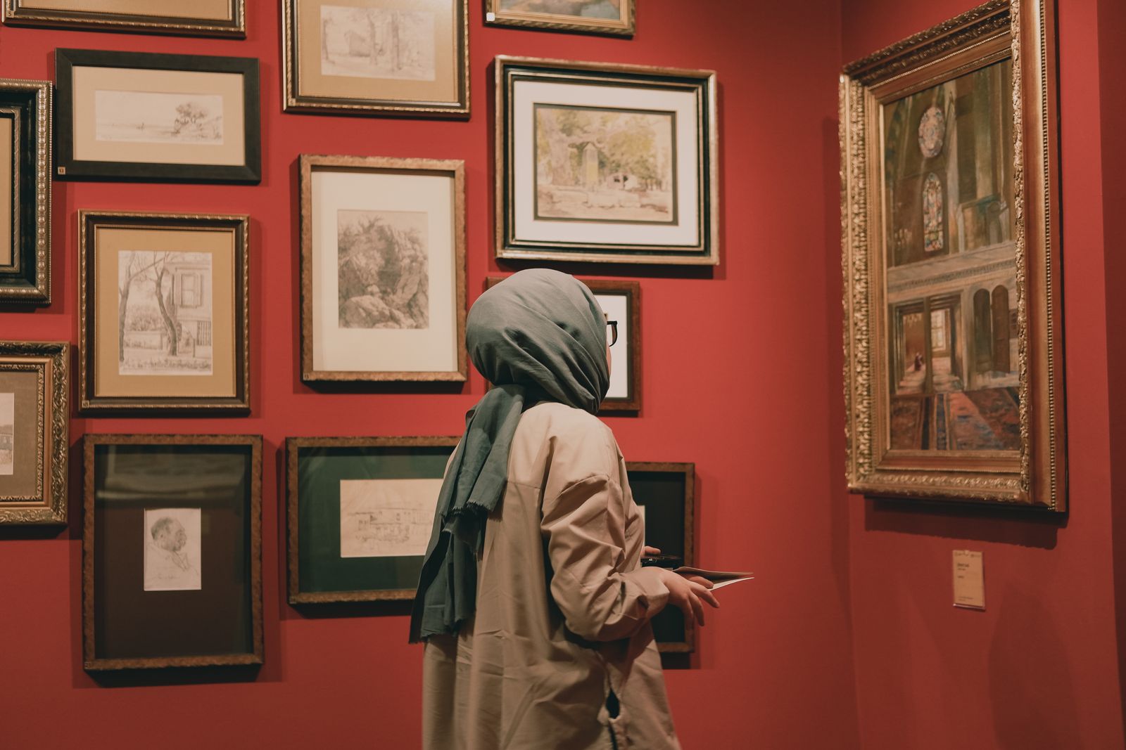 A visitor studying works in an art gallery